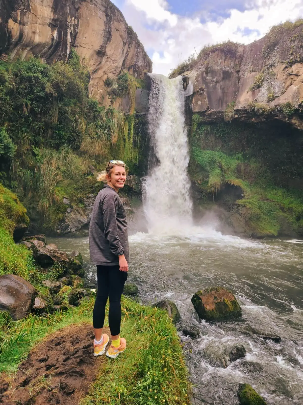 Girl standing in front of a waterfall